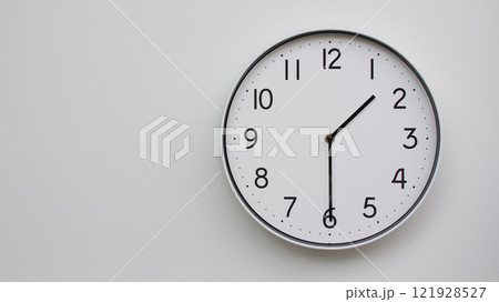 Minimalist Analog Wall Clock with White Face and Simple Black Hands Showing 13.30/01.30 - Ideal for Time Management and Modern Decor Concepts Minimalist Analog Wall Clock with White Face and Simple Black Hands Showing 13.30/01.30 - Ideal for Time Management and Modern Decor Concepts 121928527