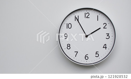 Minimalist Analog Wall Clock with White Face and Simple Black Hands Showing 13.55/01.55 - Ideal for Time Management and Modern Decor Concepts 121928532