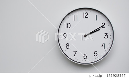 Minimalist Analog Wall Clock with White Face and Simple Black Hands Showing 14.10/02.10 - Ideal for Time Management and Modern Decor Concepts 121928535