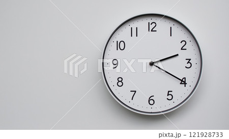 Minimalist Analog Wall Clock with White Face and Simple Black Hands Showing 14.20/02.20 - Ideal for Time Management and Modern Decor Concepts 121928733