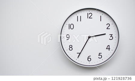 Minimalist Analog Wall Clock with White Face and Simple Black Hands Showing 14.35/02.35 - Ideal for Time Management and Modern Decor Concepts 121928736