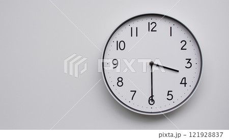 Minimalist Analog Wall Clock with White Face and Simple Black Hands Showing 15.30/03.30 - Ideal for Time Management and Modern Decor Concepts 121928837