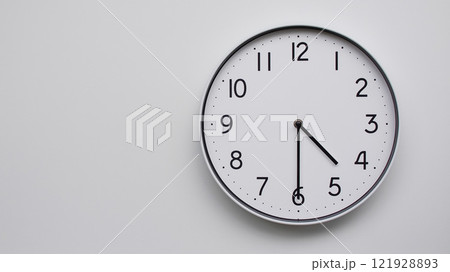 Minimalist Analog Wall Clock with White Face and Simple Black Hands Showing 16.30/04.30 - Ideal for Time Management and Modern Decor Concepts Minimalist Analog Wall Clock with White Face and Simple Black Hands Showing 16.30/04.30 - Ideal for Time Management and Modern Decor Concepts 121928893