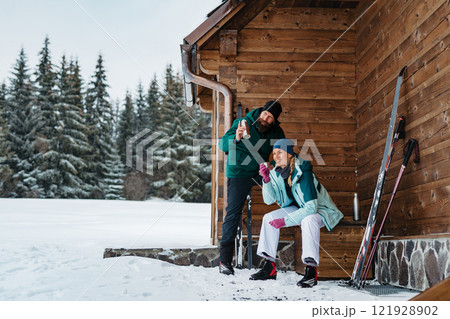 Couple spending active Valentine's weekend in the mountains, doing winter sports. Cross-country skiing in the winter wilderness. Couple spending active Valentine's weekend in the mountains, doing winter sports. Cross-country skiing in the winter wilderness. 121928902