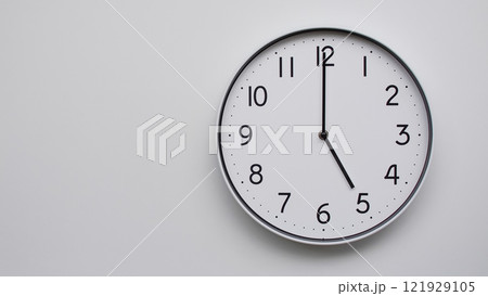Minimalist Analog Wall Clock with White Face and Simple Black Hands Showing 17.00/05.00 - Ideal for Time Management and Modern Decor Concepts Minimalist Analog Wall Clock with White Face and Simple Black Hands Showing 17.00/05.00 - Ideal for Time Management and Modern Decor Concepts 121929105