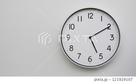Minimalist Analog Wall Clock with White Face and Simple Black Hands Showing 17.10/05.10 - Ideal for Time Management and Modern Decor Concepts Minimalist Analog Wall Clock with White Face and Simple Black Hands Showing 17.10/05.10 - Ideal for Time Management and Modern Decor Concepts 121929107