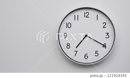 Minimalist Analog Wall Clock with White Face and Simple Black Hands Showing 19.20/07.20 - Ideal for Time Management and Modern Decor Concepts Minimalist Analog Wall Clock with White Face and Simple Black Hands Showing 19.20/07.20 - Ideal for Time Management and Modern Decor Concepts 121929345