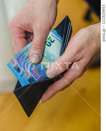 Hand Holding Wallet with Euro Banknotes Close-Up. High quality photo Hand Holding Wallet with Euro Banknotes Close-Up. High quality photo 121929955
