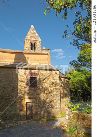Stone old chirch on mountain on sunny day. Liguria and traditional historic building. Sestri Levante, town near sea. 121931266