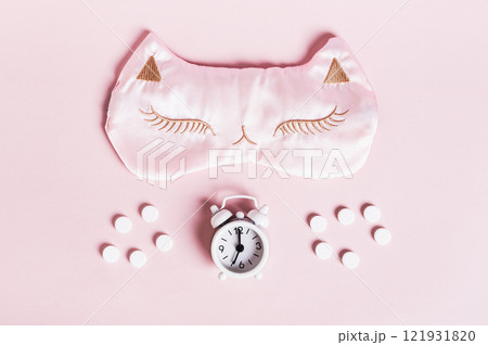 Concept insomnia sleep mask, sleeping pills and alarm clock on pink background Concept insomnia sleep mask, sleeping pills and alarm clock on pink background 121931820