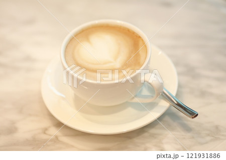 Cup of Cappuccino with Heart Shaped Latte Art on Table 121931886