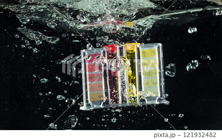 PH acid level test kit on quality water on screen. PH acid level tester kit tools fall under water splashing splattering with air bubble over black background isolated PH acid level test kit on quality water on screen. PH acid level tester kit tools fall under water splashing splattering with air bubble over black background isolated 121932482