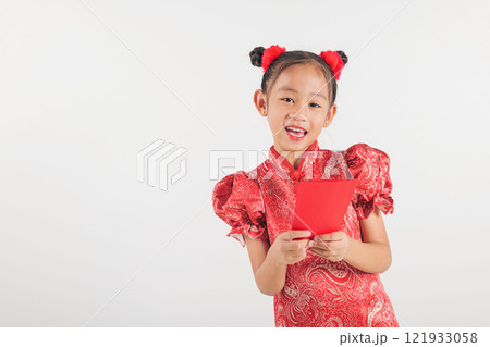 Chinese New Year. Happy Asian Chinese little kid girl smile wear red cheongsam qipao hold angpao red packet monetary gift, Portrait child in traditional dress Chinese New Year. Happy Asian Chinese little kid girl smile wear red cheongsam qipao hold angpao red packet monetary gift, Portrait child in traditional dress 121933058