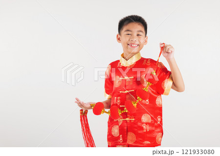 Chinese New Year. Happy Asian Chinese little kid boy smile wearing red cheongsam qipao holding silk lanterns on hand, Portrait children in traditional dress, studio short isolated on white 121933080