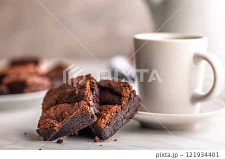 Homemade chocolate brownies and coffee cup on kitchen table. 121934401
