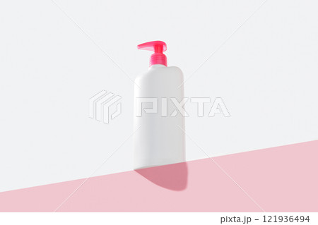 Bottle of intimate hygiene gel on pastel pink and white background. Body care concept Bottle of intimate hygiene gel on pastel pink and white background. Body care concept 121936494