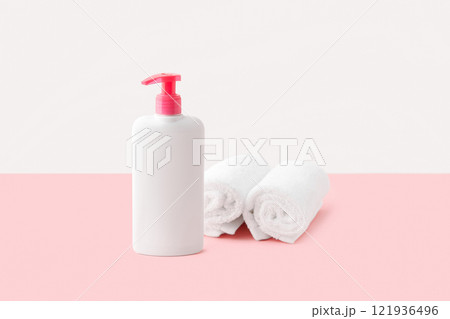 Bottle of intimate hygiene gel on pastel pink and white background. Body care concept Bottle of intimate hygiene gel on pastel pink and white background. Body care concept 121936496