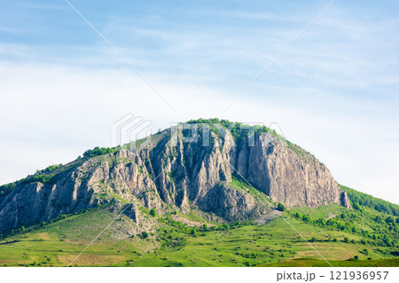 mountain landscape of romania in springtime. beautiful view. rock formation and grassy hill in morning light. scenery in valisoarei valley. spectacular country mountain landscape of romania in springtime. beautiful view. rock formation and grassy hill in morning light. scenery in valisoarei valley. spectacular country 121936957
