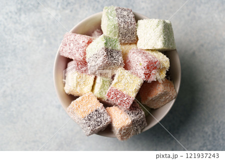 Colorful cubes of sweet confectionery arranged in a bowl ready for sharing at a gathering or celebration 121937243