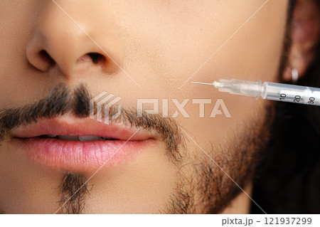 Man receiving facial treatment with a syringe for enhancing appearance 121937299