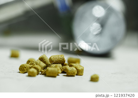 A handful of hops are scattered on a table during the brewing process A handful of hops are scattered on a table during the brewing process 121937420
