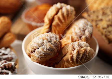 Delicious assortment of baked goods displayed in a cozy bakery setting during afternoon hours Delicious assortment of baked goods displayed in a cozy bakery setting during afternoon hours 121937470