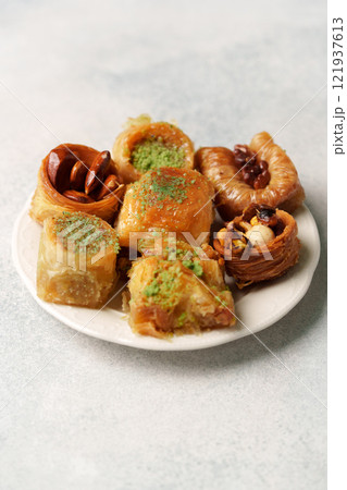 Assorted traditional sweets on a white plate showcasing rich textures and flavors 121937613