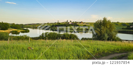 Rural landscape, nature photo, fields with wheat, background of ripening ears at sunrise, cloudy, sky background, horizon, rural meadows, country road, also, river, birch grove, Ukraine, Kharkov, prin 121937854