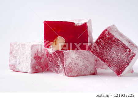 Traditional Turkish delight cubes displayed on a white background with a hint of rose flavor and nut filling 121938222