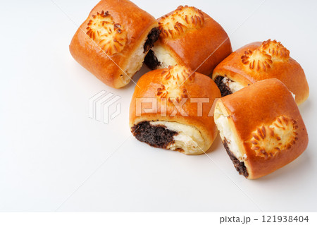 Freshly baked pastry rolls with chocolate filling and creamy center on white background Freshly baked pastry rolls with chocolate filling and creamy center on white background 121938404