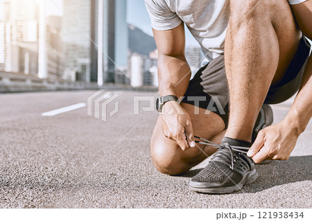 Runner getting ready for fitness running in city street, cardio training workout in town and preparing for exercise in road downtown. Active male jogging, exercising and doing physical activity 121938434