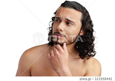 Young man with curly hair thoughtfully posing against a plain background Young man with curly hair thoughtfully posing against a plain background 121938442