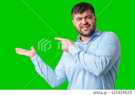 A man gesturing confidently with a bright green background 121938629