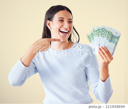 Money, investment growth and finance success of a happy, excited and smiling woman pointing at cash reward. Lucky and happy female showing her growing financial wealth, savings or bank loan payout Money, investment growth and finance success of a happy, excited and smiling woman pointing at cash reward. Lucky and happy female showing her growing financial wealth, savings or bank loan payout 121938694