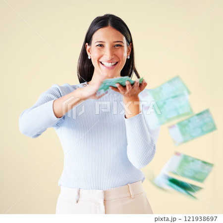 Wealthy, rich and happy woman throwing money smiling about her financial success and freedom. Portrait of an excited young female having fun and enjoying her cash and ready to spend 121938697