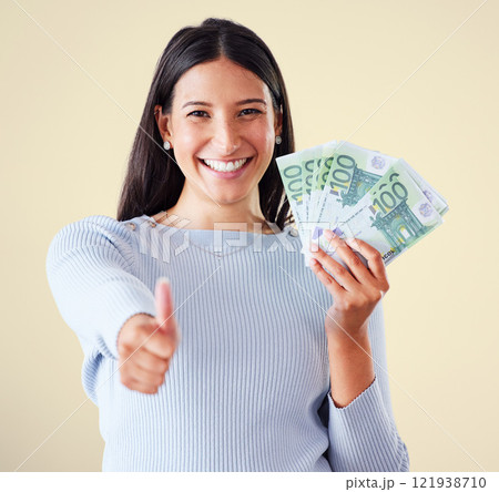 Thumbs up, money and finance growth with cash, bank notes and currency after investment, savings and lottery win. Portrait of excited, happy or motivated woman approving wealth, budget or development 121938710