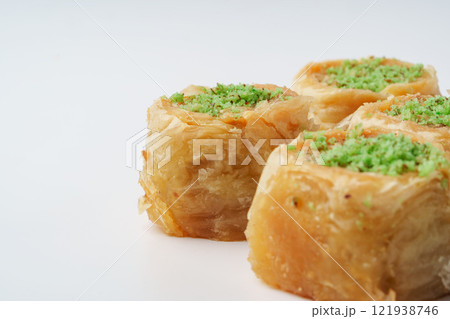 Baklava with green pistachio garnish showcases traditional dessert from Middle Eastern cuisine Baklava with green pistachio garnish showcases traditional dessert from Middle Eastern cuisine 121938746