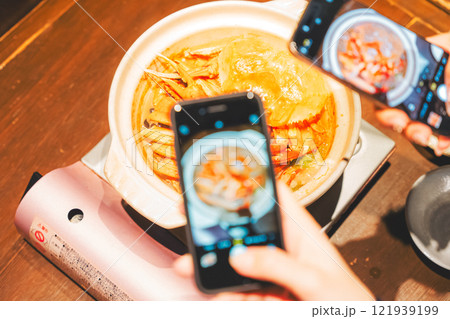 映えるカニ鍋をスマホで撮る若い女性二人【撮影協力・海鮮居酒屋 魚魯こ】 映えるカニ鍋をスマホで撮る若い女性二人【撮影協力・海鮮居酒屋 魚魯こ】 121939199