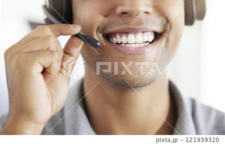 Friednly call center, customer support or contact us employee working at telemarketing company. Closeup of happy crm worker or receptionist talking in headset in agency office 121939320