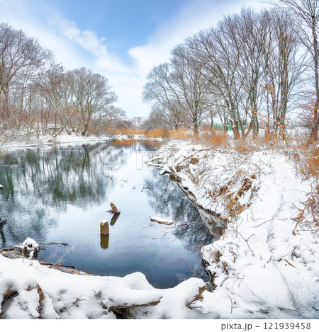 Brilliant landscape in city park with snowy trees and beautiful frozen river. Brilliant landscape in city park with snowy trees and beautiful frozen river. 121939458