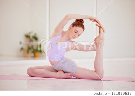 Fitness, yoga and wellness woman doing exercises, stretching and workout or pilates at a health studio or gym. Young, active and flexible fit female training or exercising for balance and healthcare 121939635