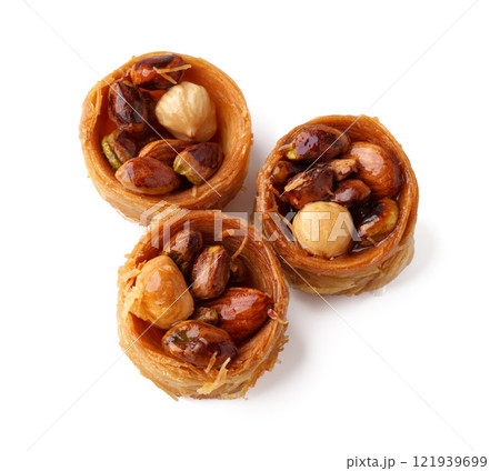 Delicious pastry filled with mixed nuts and honey syrup showcases a traditional dessert from the Middle East Delicious pastry filled with mixed nuts and honey syrup showcases a traditional dessert from the Middle East 121939699