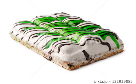 Delicious green and black striped dessert served on a flat surface during a festive gathering 121939883