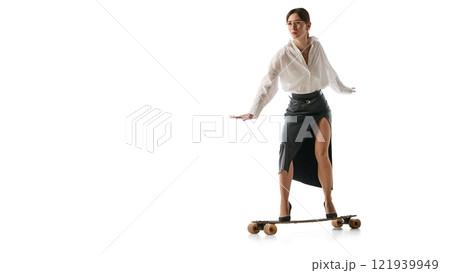 Woman in business attire balancing on longboard, symbolizing adaptability and dynamic balance in business against white studio background. Woman in business attire balancing on longboard, symbolizing adaptability and dynamic balance in business against white studio background. 121939949