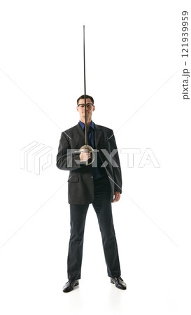 Businessman standing confidently with fencing sword, representing discipline, sharp intellect, and power in decision-making processes against white studio background. 121939959