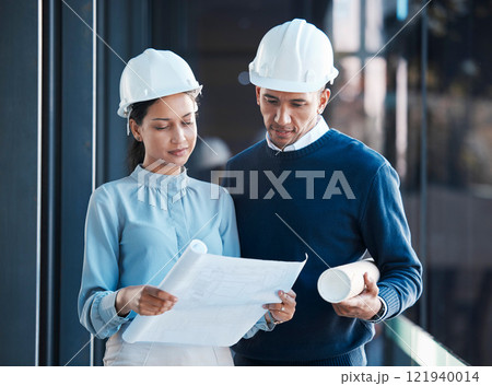 Architecture, civil and architect engineers busy with a floor plan or blueprint strategy on paper inside a office building. Designers working, planning and analyzing a construction project together 121940014