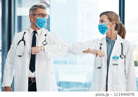 Elbow greeting, doctors and medical healthcare workers with covid 19 virus safety masks in a hospital portrait. Life, emergency and wellness social distancing to stay safe. Employee ready for service 121940076