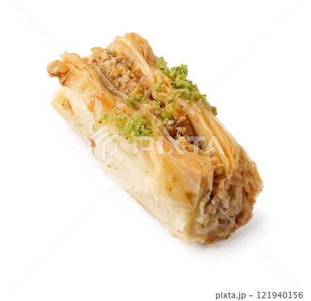 Delicious baklava topped with crushed pistachios served on a plain background for a tempting dessert experience Delicious baklava topped with crushed pistachios served on a plain background for a tempting dessert experience 121940156