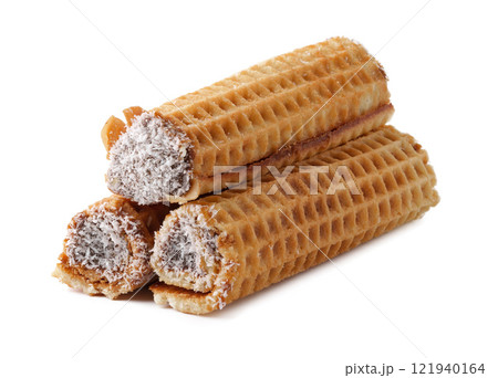 Delicious rolled wafers filled with chocolate cream and coated in coconut flakes displayed on a clean background Delicious rolled wafers filled with chocolate cream and coated in coconut flakes displayed on a clean background 121940164