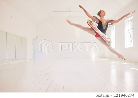 Jumping or leaping female ballerina, ballet dancer or performer in a traditional tutu dress costume in a studio with copy space background. Young professional performer dancing in ballon mid air pose Jumping or leaping female ballerina, ballet dancer or performer in a traditional tutu dress costume in a studio with copy space background. Young professional performer dancing in ballon mid air pose 121940274